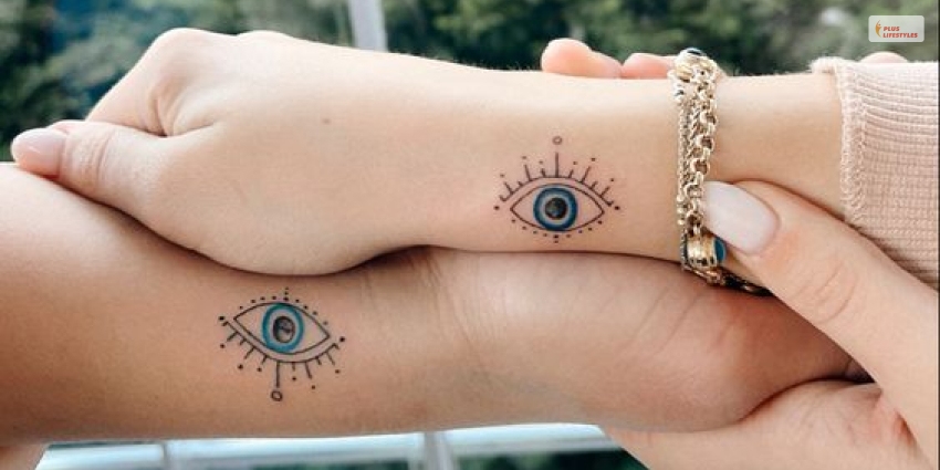 Matching minimalistic evil eye tattoo for sisters